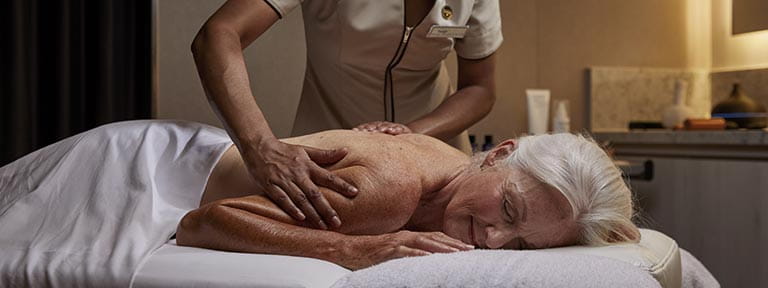 A female passenger enjoying a massage in the Spa on Spirit of Adventure